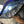 Load image into Gallery viewer, Person holding a reflective car sunshade in front of a vehicle window
