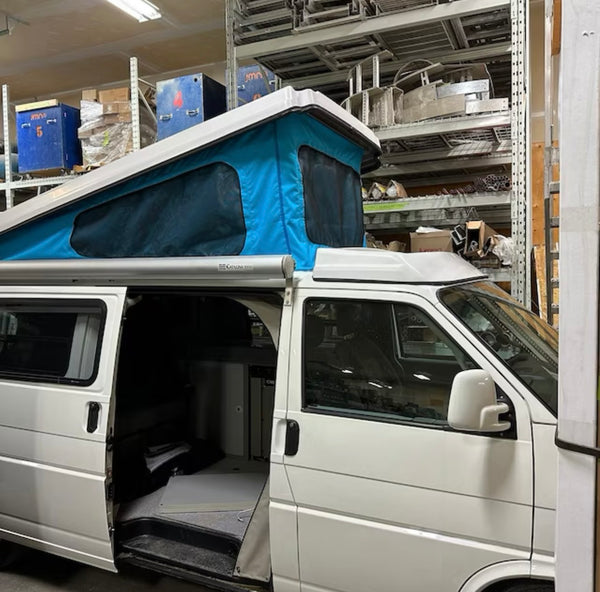Side view of VW Eurovan Winnebago with 3-window pop-top canvas installed