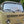 Load image into Gallery viewer, Beige Volkswagen van with a clear windshield on a street
