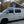 Load image into Gallery viewer, Side view of VW Eurovan Winnebago with 3-window pop-top canvas installed
