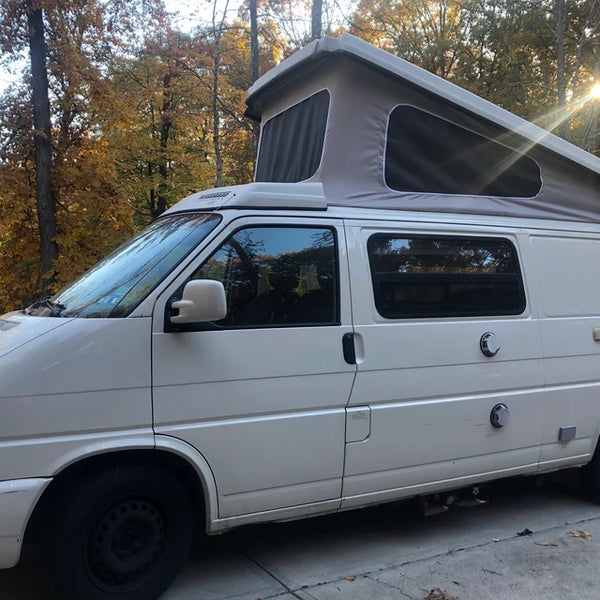 Side view of VW Eurovan Winnebago with 3-window pop-top canvas installed